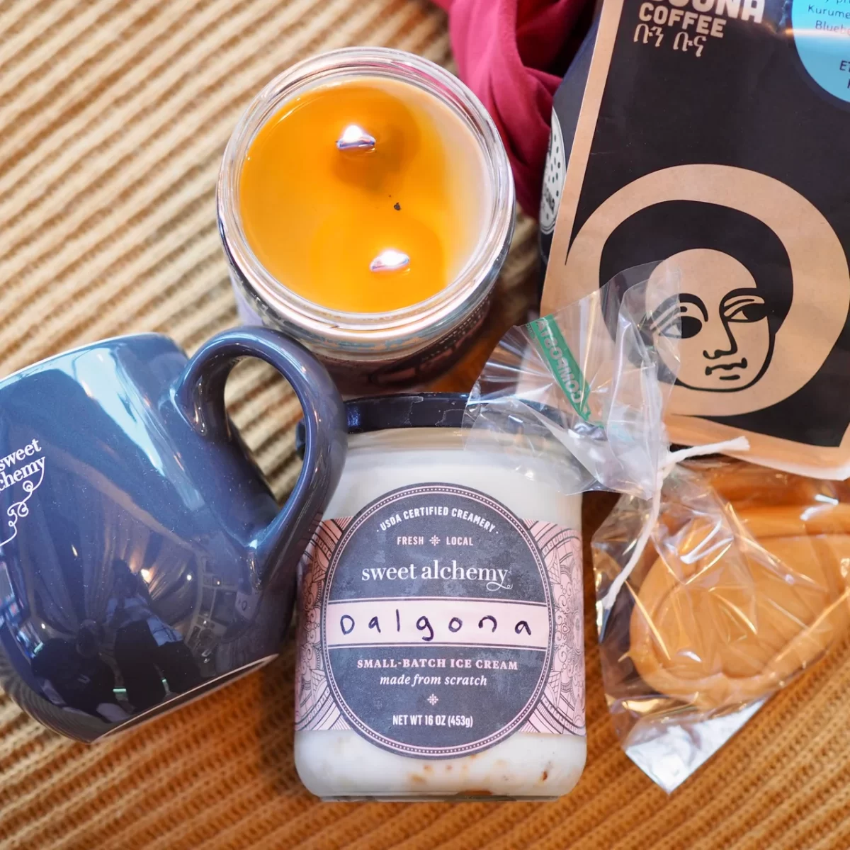 A set of items, including a scented candle, mug, and Boon Boona ethiopian coffee roasts